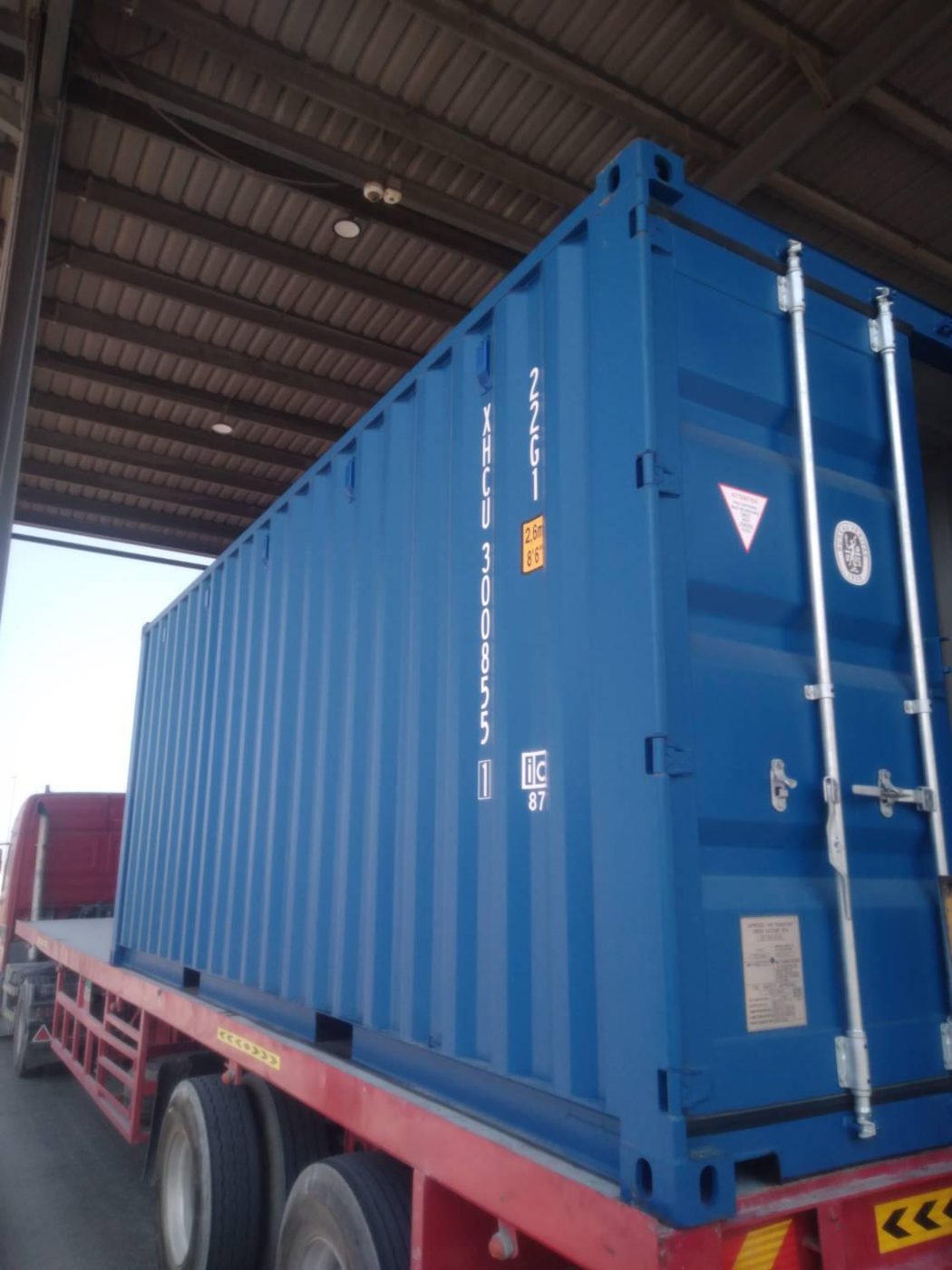 New blue 20ft container loaded on a delivery truck in the UAE