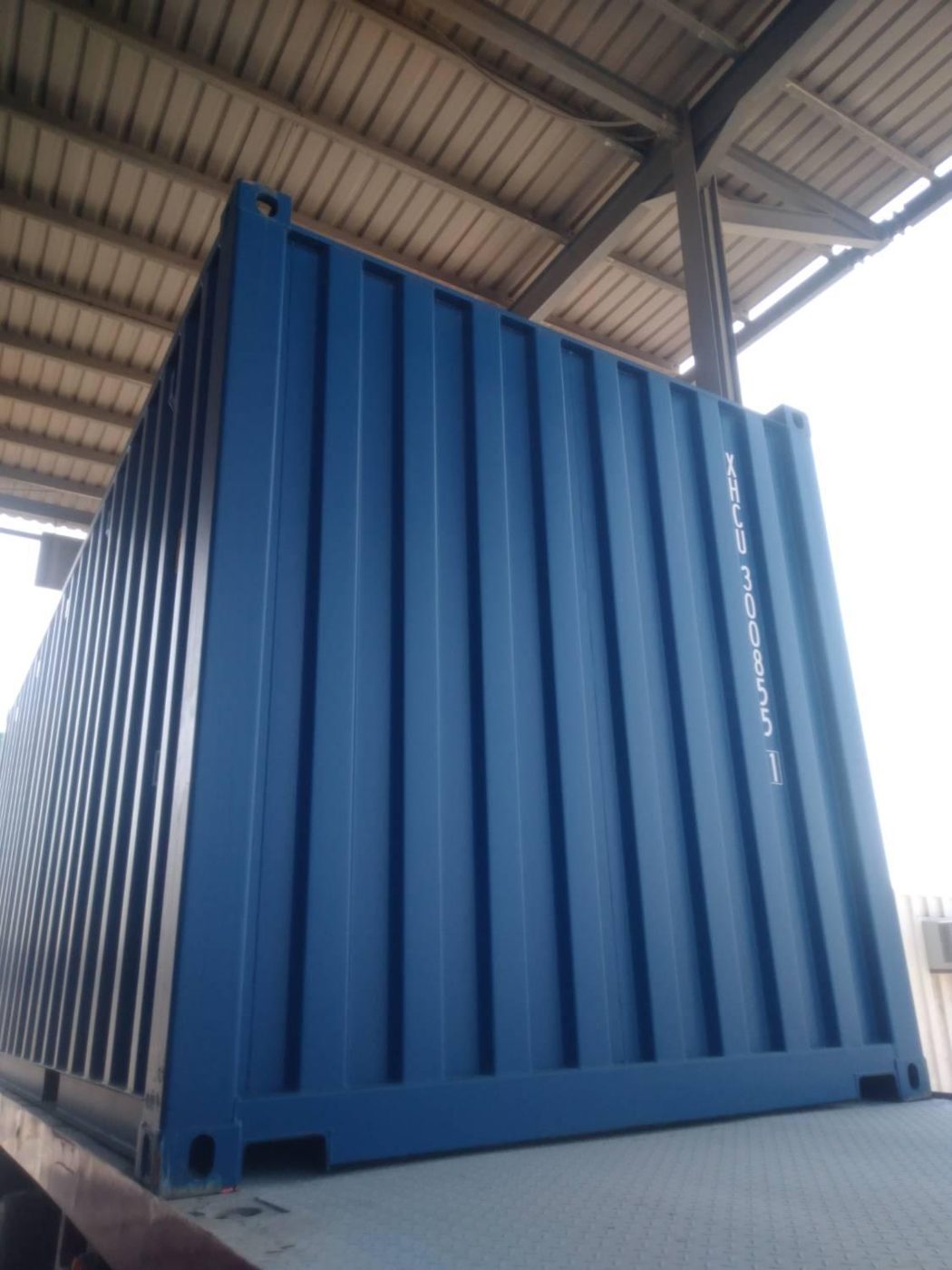 Brand new blue 20ft shipping container, side view, UAE