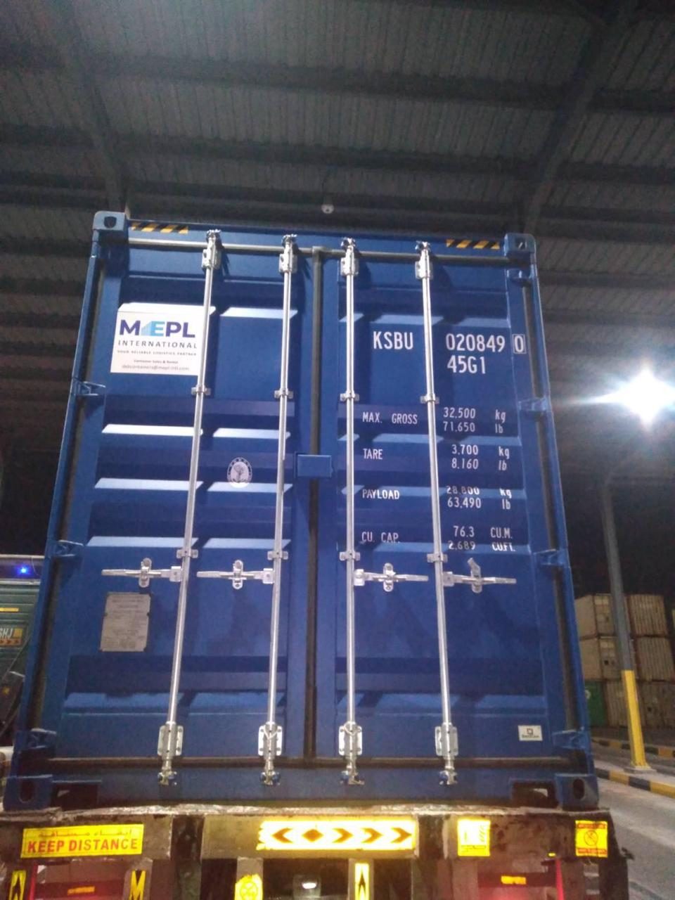 New blue 40ft high cube container with doors closed on a trailer