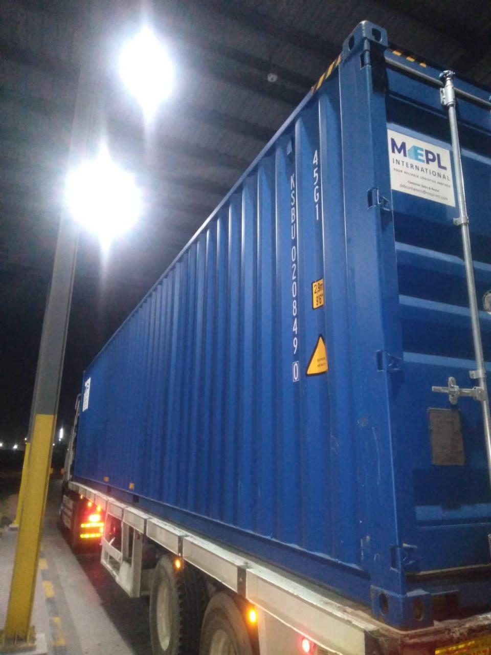 New blue 40ft high cube container on a delivery trailer